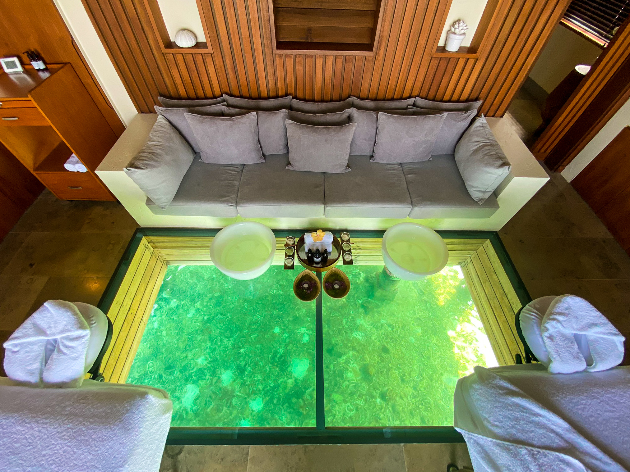 Waldorf Astoria Maldives Ithaafushi overwater spa treatment villa glass floor